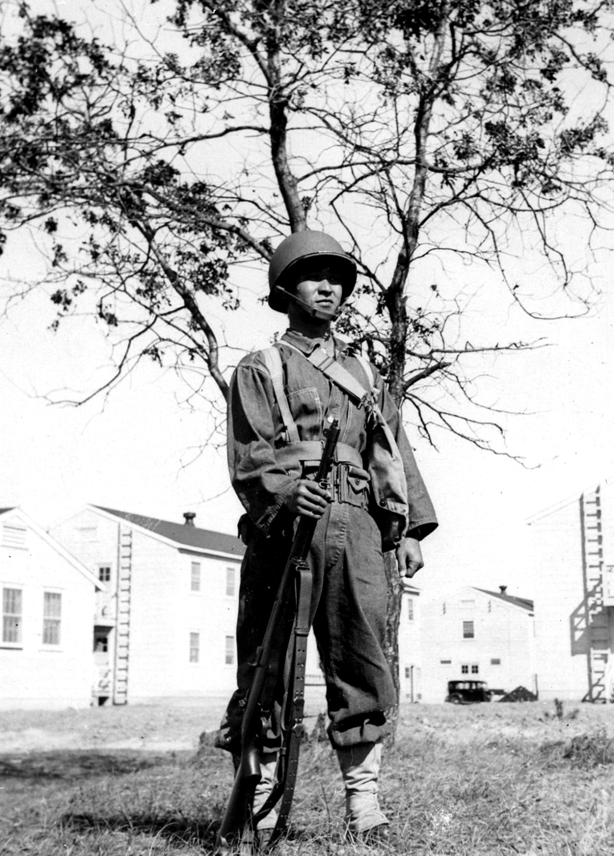 Kuazo-Yamane-holds-an-M1-rifle-while-assigned-to-the-100th-Infantry-Battalion-Separate-in-1942-at-Camp-McCoy-Wisconsin