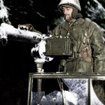 Pvt Charles Preston (Nicholasville Kentucky) brushes snow away from Water Cooled M-1917