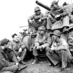 88-ID (H-2350) Monterumici April 1945-009-With goggles atop his head, Ernie Pyle talks to a group of soldiers near Anzio, Italy,1945