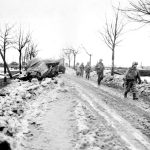 2nd Division Infantrymen pass the bodies of dead Germans and knocked-out equipment as the break out of the Monschau Forest-(1024)