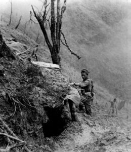 A-Gurkha-examines-a-Japanese-bunker-Scraggy-hill-1944