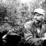 CPT Erik J. Anderson of the Arakan Field Unit MU section leads a rubber boat team down a chaung (tidal creek), Burma