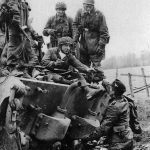 Fallschirmjägers resting on the rear deck of a King Tiger in the Ardennes December 1944
