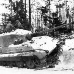 American soldiers on a German Tiger II (Royal Tiger) tank which had been knocked out by American Air Force fighter-bombers during the Battle of the Bulge, the German counter-offensive of December 1944 in the Ardennes area of Belgium.     Date: December 19