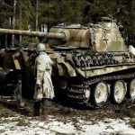 A soldier from the 9th US Army Air Corps stands next to an abandoned or destroyed German PzKpfw. V Ausf. G “Panther”, Ardennes, Belgium, December 1944
