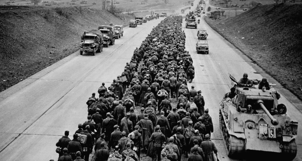 04 May 1945, Germany --- Thousands of German prisoners march along a modern German superhighway while their allied captors travel in tanks, trucks, and jeeps. May 4, 1945