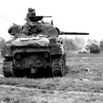 [Holland] A Sherman of the 2nd Armored Division preparing to fire on a German position near Nieuwstadt, Holland. September 29, 1944
