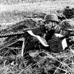 [Holland] Three German paratroopers from the 5th Parachute Division in a trench with a captured American Browning M1919 A4 machine gun 1944