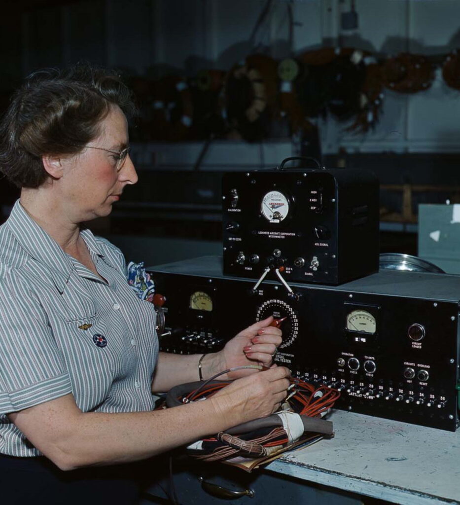 An employee of Douglas Aircraft Company works with electrical wiring at the plant in Long Beach, California. 1942