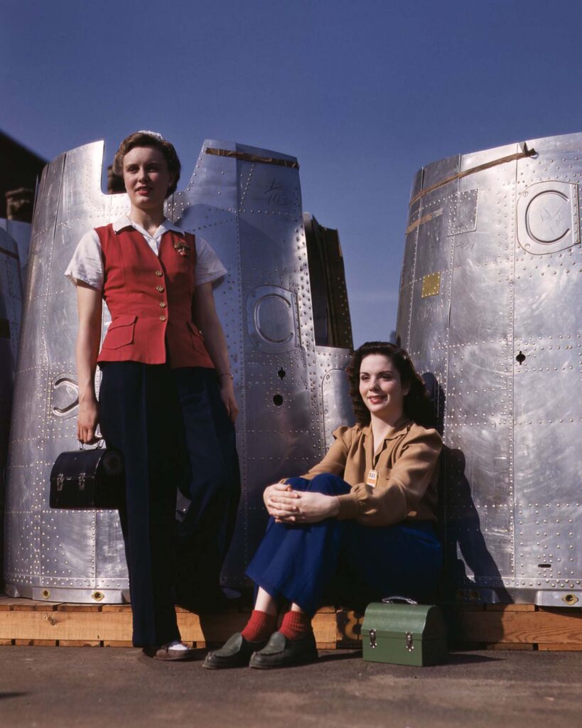 Two assembly workers take a lunch break next to heavy bomber nacelle parts at the Douglas Aircraft Company plant in Long Beach, California. 1942 Two assembly workers take a lunch break next to heavy bomber nacelle parts at the Douglas Aircraft Company plant in Long Beach, California. 1942