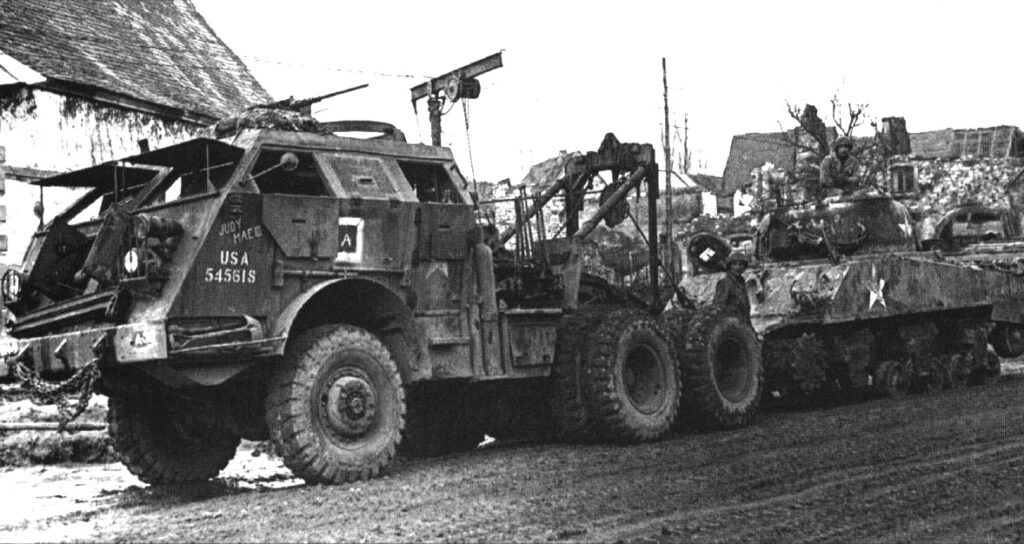 M26 tractor 'Judy Mae III' of the 134th Ordnance Maintenance Battalion recovering a disabled Sherman of 12th Armored Division. France, December 1944