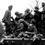 Men of the 9th Fallschirmjäger Regiment, 3rd Fallschirmjäger Division hitching a ride on Mark VI-2 King Tiger #222 of the 501st Heavy SS Panzer Battalion on December 17, 1944