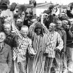 Prisoners at Dachau Cheer Approaching American Soldiers
