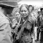 Suspected Viet Cong soldier carrying a Russian-made rifle, awaiting interrogation. August 25, 1965. Courtesy of Associated Press