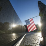 Soldier at the Vietnam Memorial wall