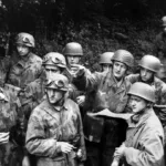 German paratroopers in Normandy consult a map and plan a strategy to try and halt the American advance