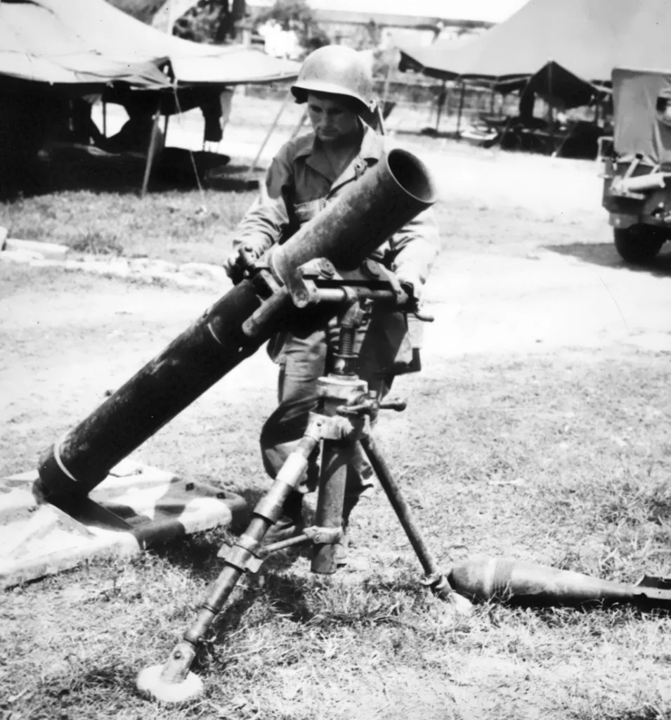 Somewhere in the Pacific: a US soldier examines a captured Japanese 150-MM Jap Mortar, believed to be the largest used by the enemy in this Theater of Operation. Almost twice the size of American mortars, the weapon weighs more than 700 pounds and requires a crew of 10 men