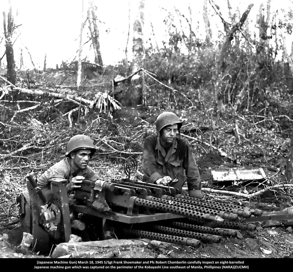 March 18, 1945 - S/Sgt. Frank Shoemaker and Pfc. Robert Chamberlin carefully inspect an eight-barrelled Japanese machine gun which was captured on the perimeter of the Kobayashi Line southeast of Manila, P.I. (NARA)