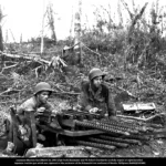 March 18 1945-SSgt Frank Shoemaker and Pfc Robert Chamberlin inspect an eight-barrelled Japanese machine gun which was captured