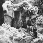 Searching surrendering Japanese Soldier for Concealed Weapons or Hand Grenade – Okinawa 1945