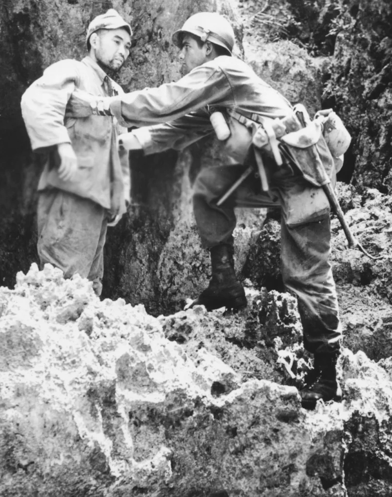 Searching surrendering Japanese Soldier for Concealed Weapons or Hand Grenade - Okinawa 1945