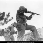 Soldiers of the 96th Infantry Division attack Japanese positions on Big Apple Ridge