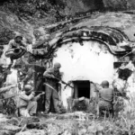 Battle of Okinawa – May 1945 – Men clearing a traditional burial tomb