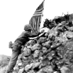 Lieutenant Colonel R.P. Ross, Jr., of Frederick, Md., plants the American flag on one of the remaining ramparts of ancient Shuri castle on Okinawa