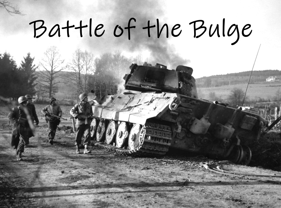 American soldiers pass an abandoned and burning German Tiger tank, which may have simply run out of gas before being wrecked, as they patrol outside La Gleize, Belgium, late Dec. 1944 or early Jan. 1945. (AP Photo/Peter J. Carroll)