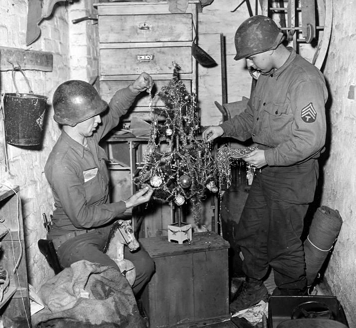 Al over the entire font line, December 1944 - US Army infantrymen of the 84th Training Command decorate a Christmas tree