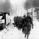 82nd Trooper escorting German Pows to the Cage Jan 1945