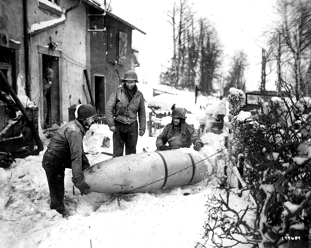 American-soldiers-of-the-1st-Division-move-a-German-resupply-container-dropped-in-Sourbrodt-Belgium-January-1945
