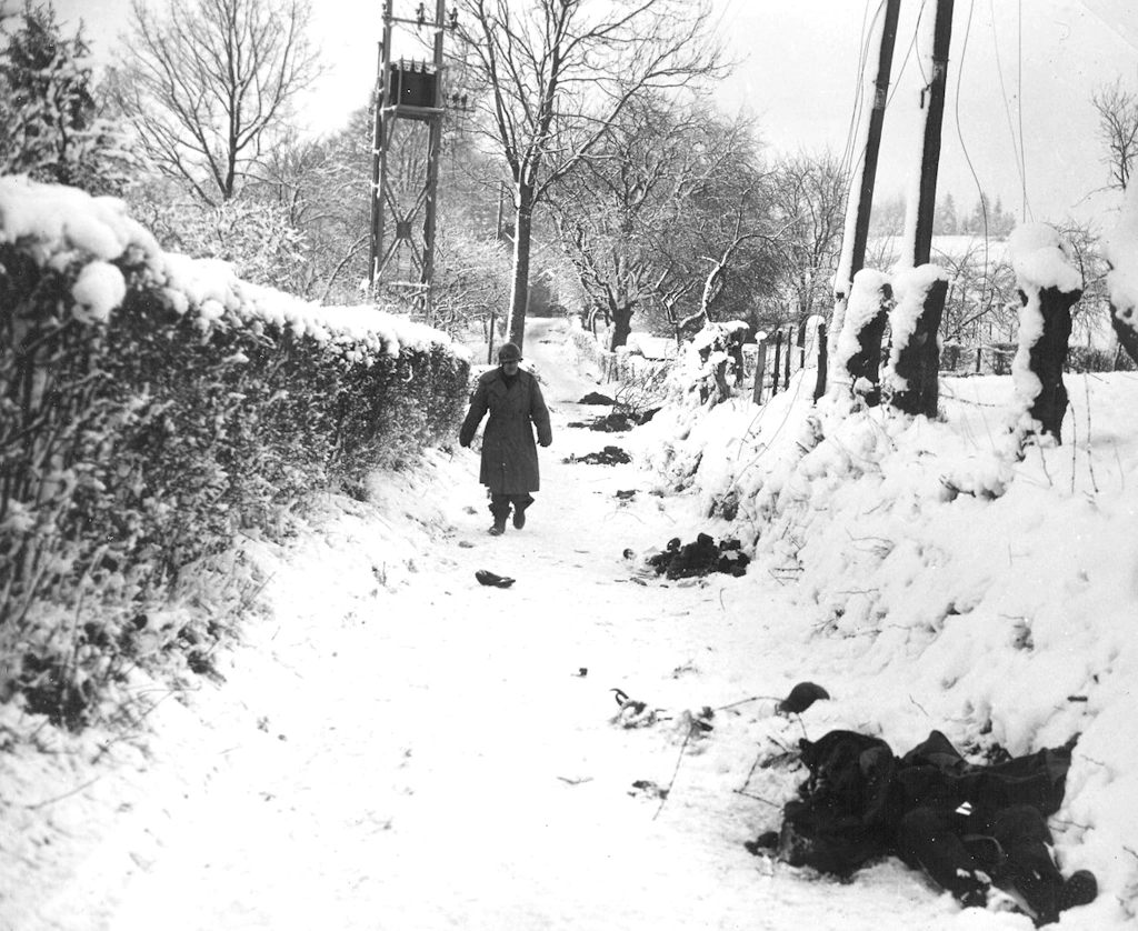 Belgium, Battle of the Bulge, January 1945, A soldier of the 82nd Airborne check the enemy deads (troop identification) after eliminating a strong point (Location Unknown).webp
