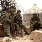 Malmedy, December 29 1945, Sgt Lyle Greene, SSgt Joseph DeMott, and Pfc Fred Mozzoni, 30th Infantry Division, take five