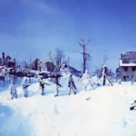 snowsuited-soldiers-walk-through-the-snow-covered-rubbles-of-st-vith-belgium-January 1945