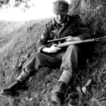 A German sniper from a Gebirgsjäger unit (Mountain Riflemen) cleans his rifle during the Italian Campaign on the Gothic Line along the summits of the Apennines. Emilia-Romagna, Italy. September 1944