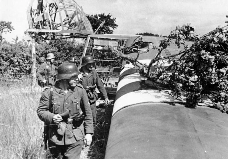 An-abandoned-Waco-CG-4-glider-is-examined-by-German-troops