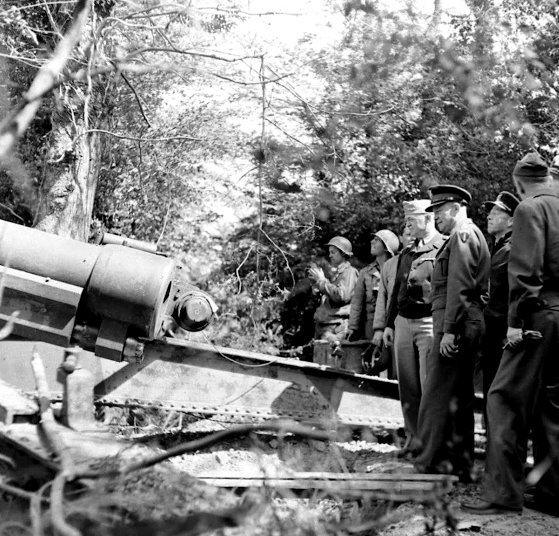 June 12, 1944, Cricqueville-en-Bessin, where the guns from La Pointe du Hoc had been stored. Those were 155-MM K418(f) guns — (French 155-MM GPF (Grande Puissance Filloux) long-range guns — modified by the Germans and moved further inland, were found by Rangers S/Sgt Leonard Lomell and Sgt Jack E. Kuhn