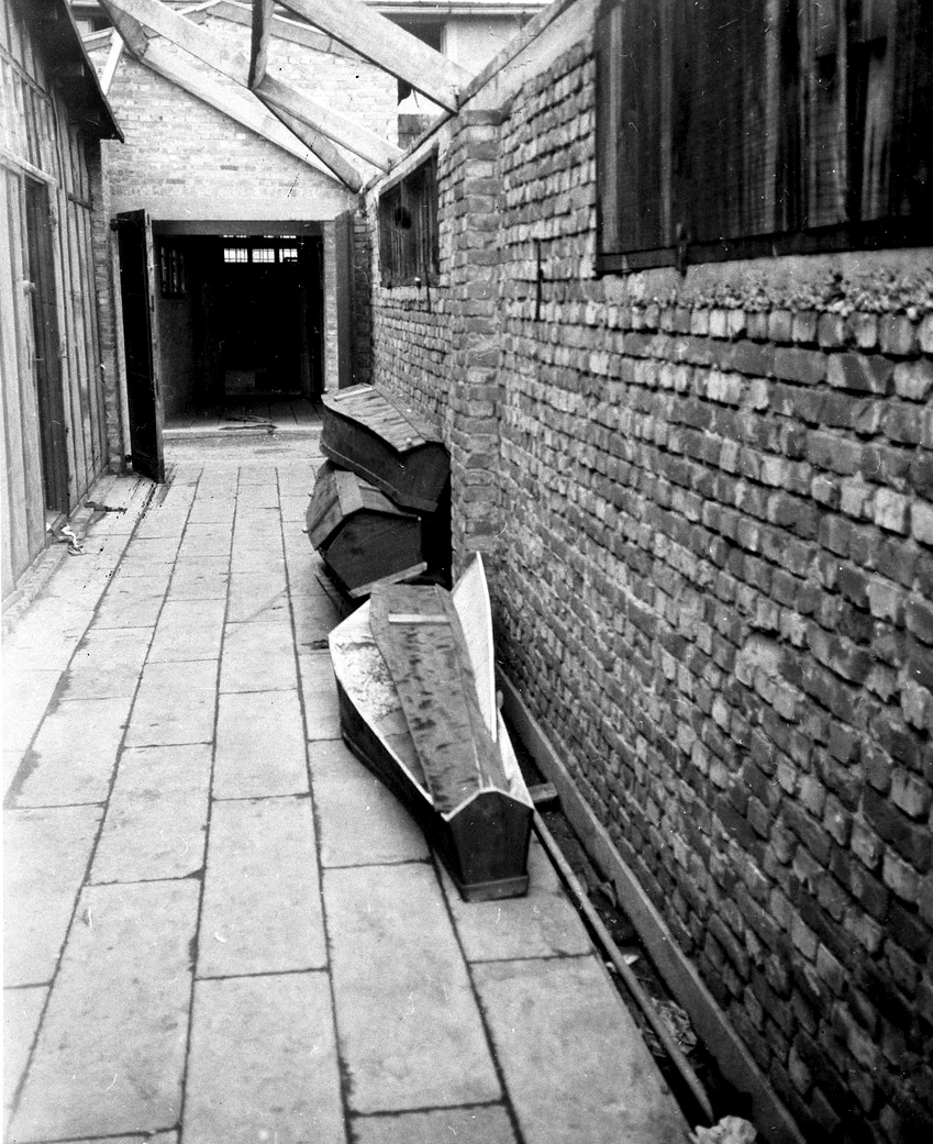 View of coffins left by the side of a wall in the Breendonk concentration camp