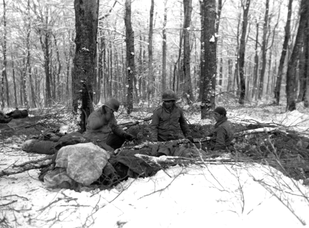 US troops in their foxholes in the Belgian Ardennes Forest facing the first snow of December 1944