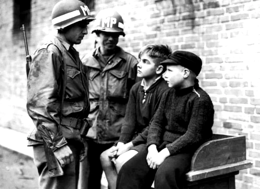 American MPs with two German boys, who are being held after shooting at U.S. troops in Aachen, Germany American MPs with two German boys, who are being held after shooting at U.S. troops in Aachen, Germany