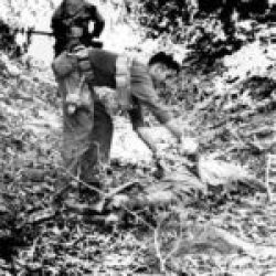 5307-GALAHAD-Walawbum-1944-(EUCMH)-013-Walawbum – Marauder Phil Piazza checks enemy body for material valuable for intelligence purposes