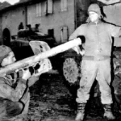 90th Infantry Division GIs from the unit’s 712th Tank Battalion point to the damage done to their M4 Sherman by a German Panzerschrek. The photo was taken in Metzervisse, France on November 17, 1944
