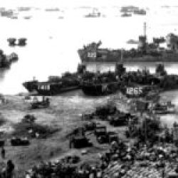 American ships landing troops and supplies on a beach on Okinawa, Japan, 13 April 1945
