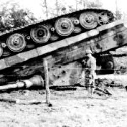 American soldiers with a German Tiger II heavy tank from the SS-Panzer-Abteilung 101, lying upside down. France, 1944.