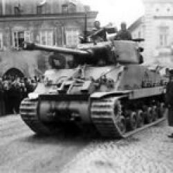 An American M4A3 (76mm) W HVSS Sherman tank of 4th Armored Division in front of the Hotel Fialka, Sušice, 6 May 1945.