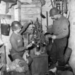 (Christmas 1944 – Illustration) 84th-Division-GIs-trim-tree-Geilenkirchen-Germany-1944