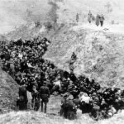 Einsatzgruppen soldiers shooting Jews who are in a ditch-0