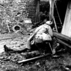 FUSA, Germany, December 10, 1944. A Medic of the 104-ID heals a bazooka shooter who has just been injured