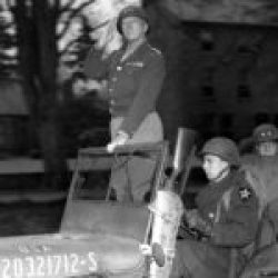 Gen George S. Patton (3-A) with Gen Walter Robertson (2-ID) pass in review of Third Army Troops in Armagh, April 1, 1944-(scalled)